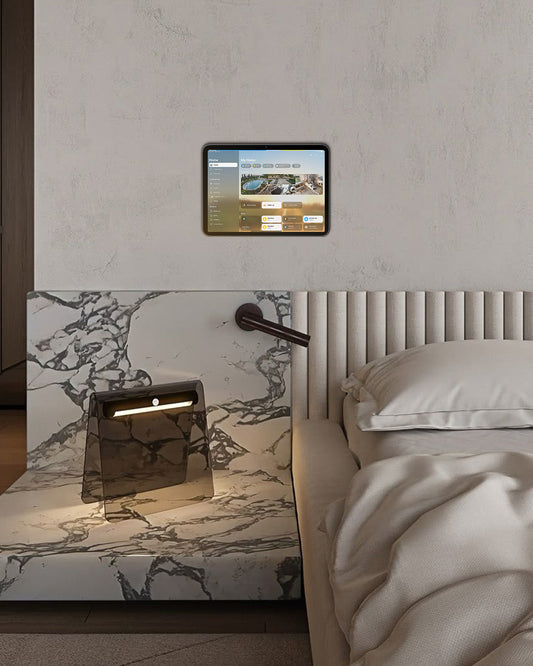 Bedroom with wall-mounted tablet used to control lights and blinds